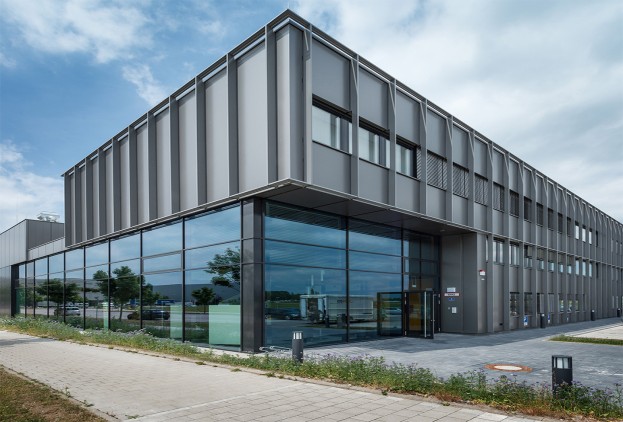 A building clad in heroal grey with a glass façade